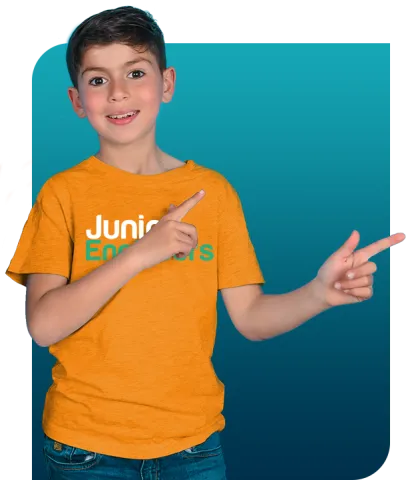 Boy in Junior Engineers shirt pointing sideways