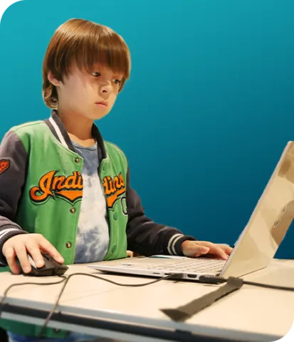 Young boy learns coding at parent's workplace in school holidays